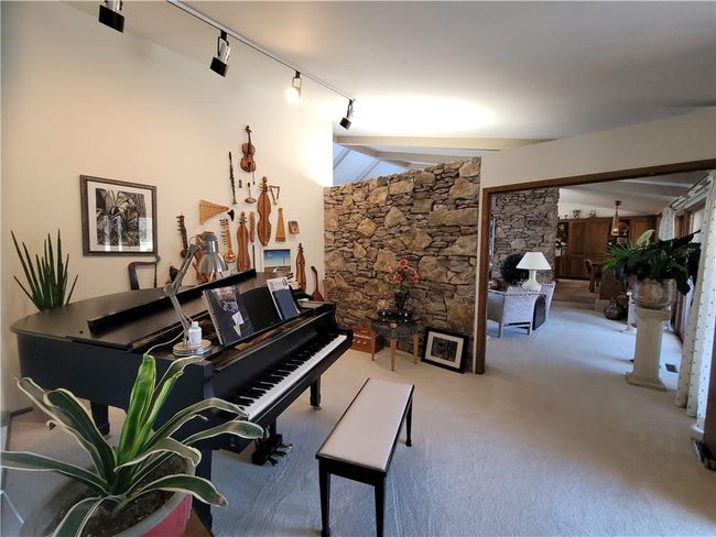 Living area with rail lighting and carpet flooring | Image 14