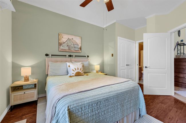 Bedroom featuring crown molding, wood finished floors, a ceiling fan, baseboards, and a closet | Image 19