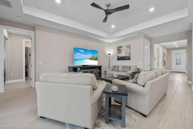 Living area featuring visible vents, baseboards, ceiling fan, recessed lighting, and a raised ceiling | Image 27