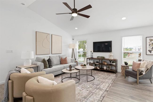 Living room with ceiling fan, light hardwood / wood-style flooring, vaulted ceiling, and a wealth of natural light | Image 16