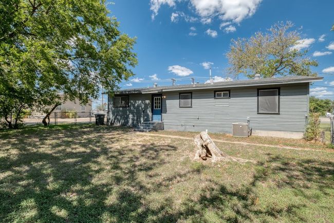 Rear view of property with central AC unit, fence, and a yard | Image 22