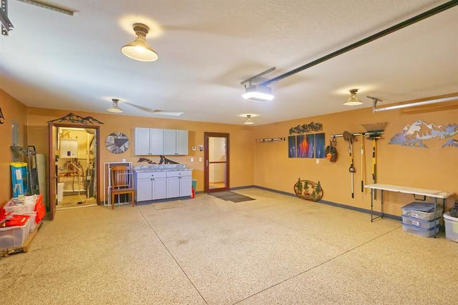Garage space noting the utility room and entrance to the home | Image 21