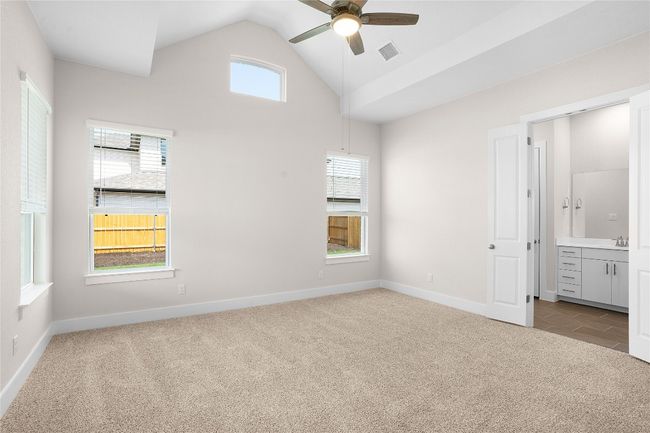 Unfurnished bedroom with carpet, vaulted ceiling, baseboards, ensuite bathroom, and a sink | Image 12