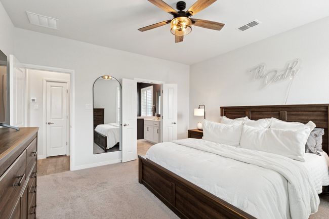 Bedroom featuring light carpet, ensuite bath, and a ceiling fan | Image 14