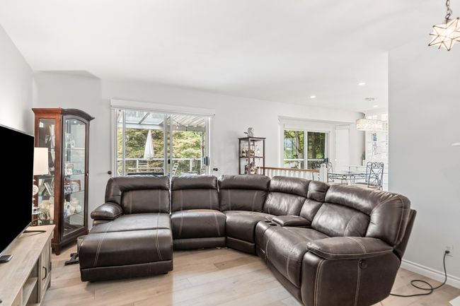 Living area with light wood-style floors and recessed lighting | Image 20