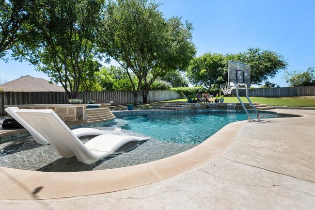 View of swimming pool featuring a fenced backyard | Image 28