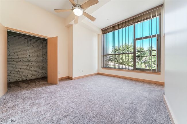 Unfurnished bedroom featuring carpet, walk-in closet, and a ceiling fan. | Image 28