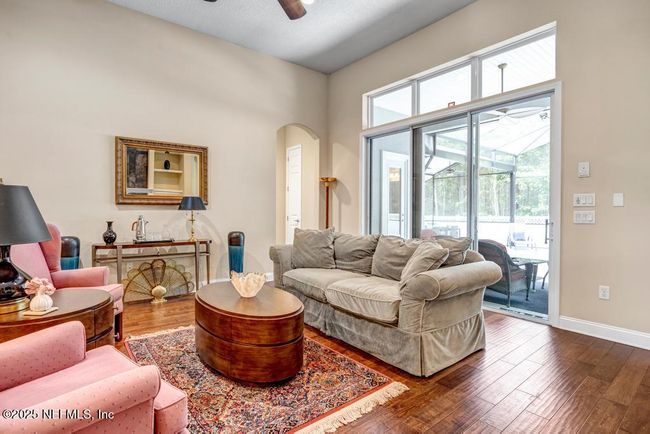 Large open family room leading to huge screened in pool/spa, seating and dining area | Image 16