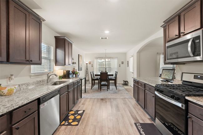Kitchen with stainless steel appliance and LVP flooring | Image 11