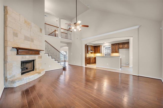 The stunning stone fireplace is the centerpiece of this elegant living room. | Image 15