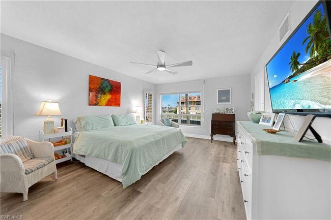 Bedroom with ceiling fan and light wood-type flooring | Image 20
