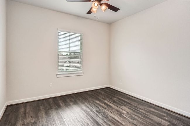 Unfurnished room with a ceiling fan, dark wood finished floors, and baseboards | Image 23