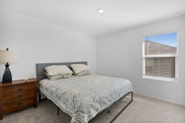 Bedroom featuring light carpet and baseboards | Image 26