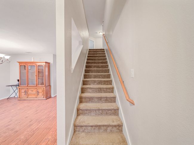 Stairs featuring wood finished floors, baseboards, and a chandelier | Image 18