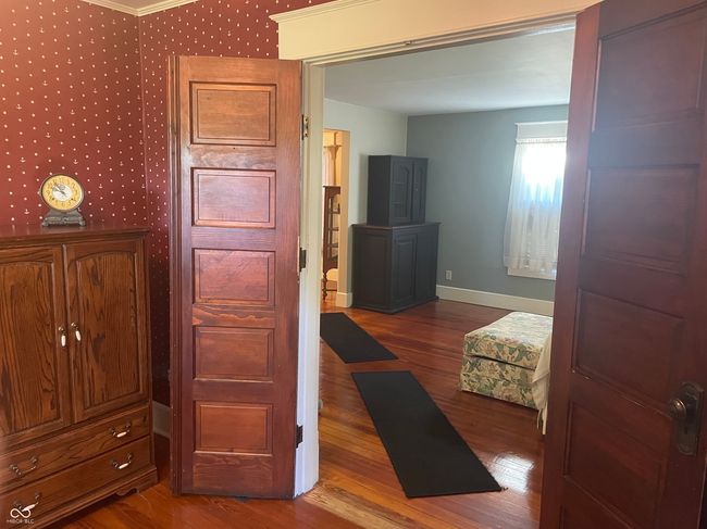 View into the LR, wood finished floors, baseboards, and ornamental molding | Image 11
