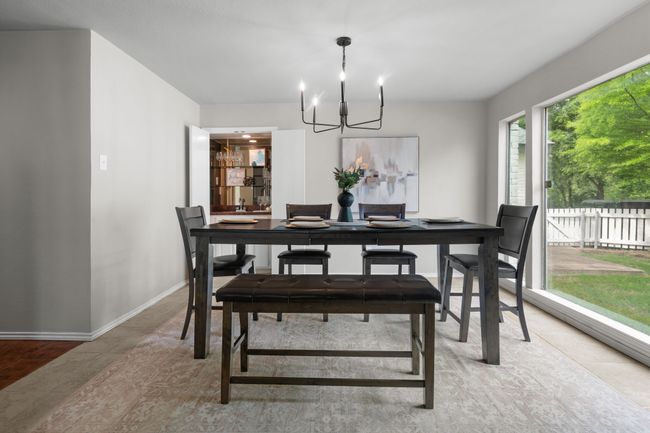 Dining space featuring a chandelier and wet bar | Image 5