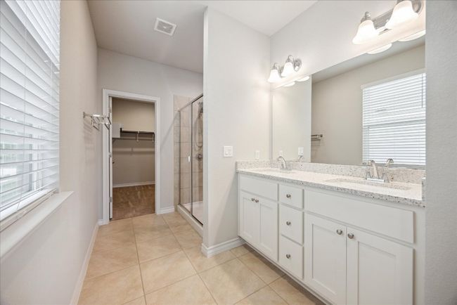 Full bathroom with a sink, a healthy amount of sunlight, a shower stall, and visible vents | Image 12