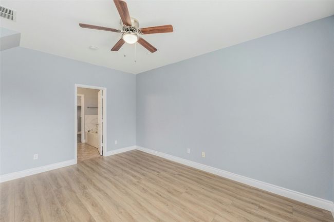 Empty room featuring ceiling fan and light wood-style flooring | Image 15