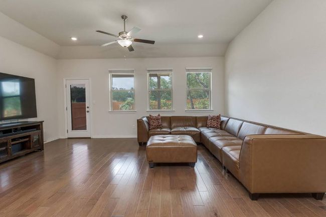 Living room featuring a ceiling fan, wood-type flooring, baseboards, and recessed lighting | Image 13