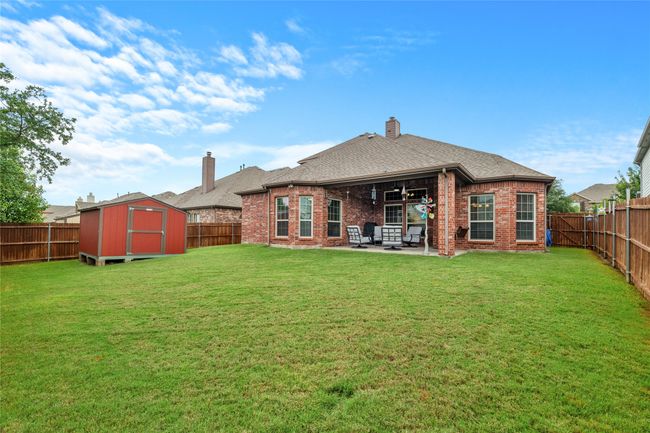 Back of house with a patio area, a chimney, and a fenced backyard | Image 37