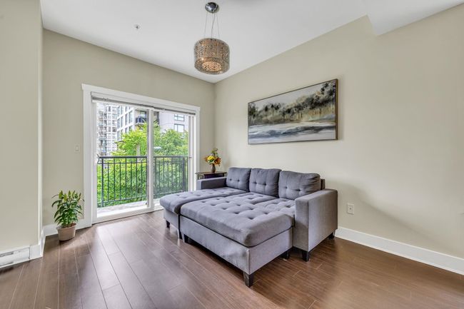 Sitting room featuring dark wood finished floors and baseboards | Image 11