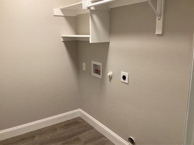 Washroom with hookup for a washing machine, electric dryer hookup, dark wood-type flooring, and gas dryer hookup | Image 29