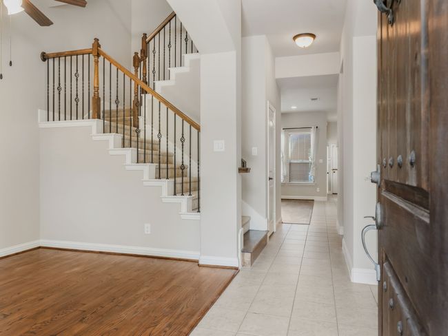 Entryway featuring light wood-type flooring, stairway, and a ceiling fan | Image 4