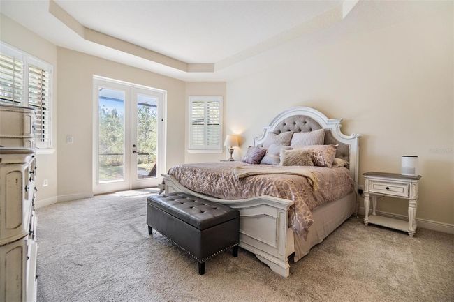 Master bedroom provides direct access to lanai through the French doors | Image 11