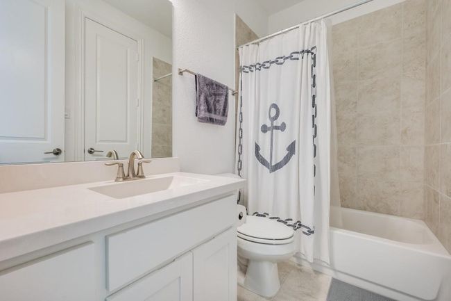 Bathroom featuring vanity, toilet, and shower / bath combo with shower curtain | Image 28