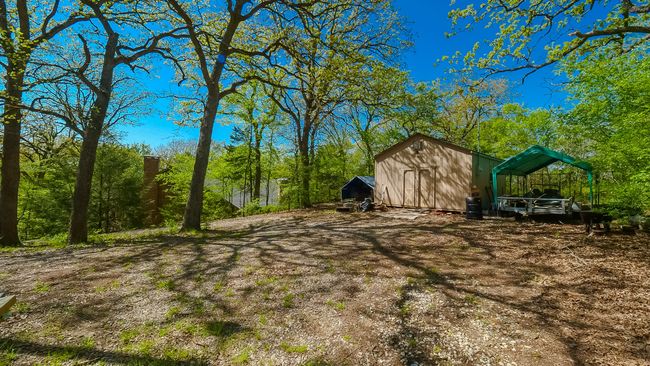 View of yard featuring a shed and an outdoor structure | Image 30