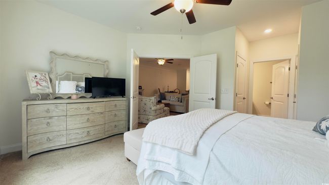 Bedroom with light colored carpet and ceiling fan | Image 27