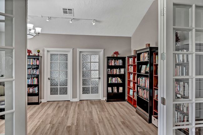 Interior space with wood finished floors and a chandelier | Image 23