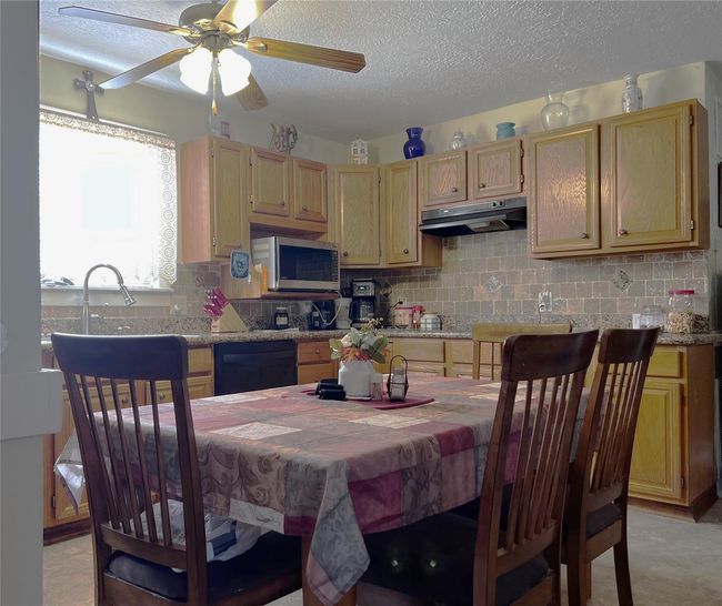 Entering the home, the dining area and kitchen are on the left. | Image 18