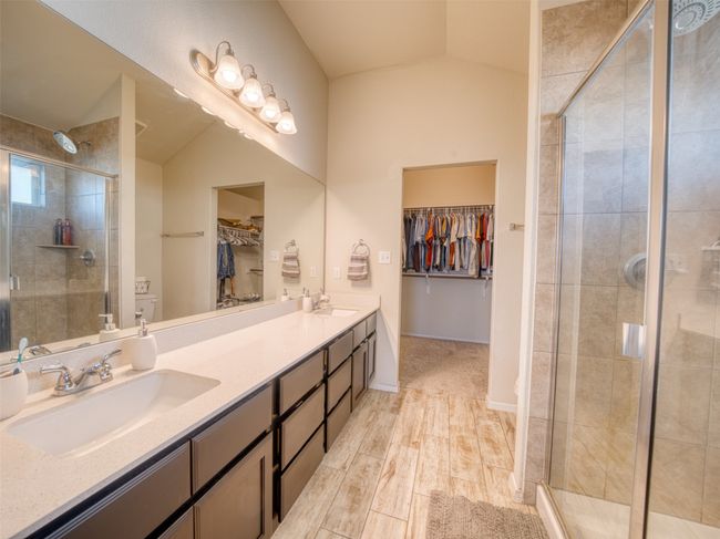 Bathroom featuring vaulted ceiling, an enclosed shower, and vanity | Image 11
