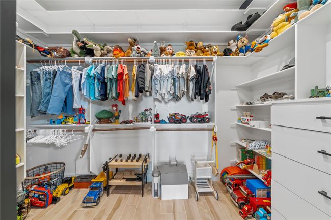 Walk in closet featuring wood finished floors | Image 34