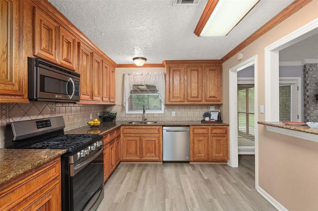You will Love this Kitchen with Plenty of Cabinet & Counter Space Plus a Breakfast Bar | Image 6