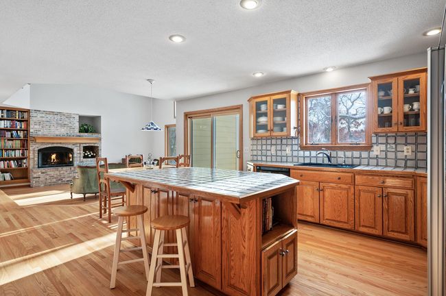 The open floor plan maximizes views from every room and creates easy living and entertaining spaces. The center island offers additional storage and is great for a quick snack or additional seating for guests. | Image 10