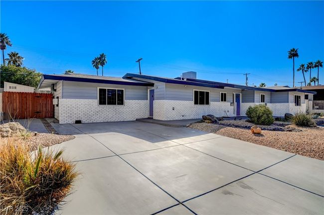Ranch-style home featuring brick siding, driveway, and fence | Image 25