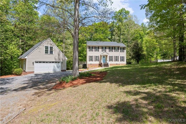 Colonial inspired home featuring a garage, entry steps, an outdoor structure, crawl space, and a front yard | Image 41