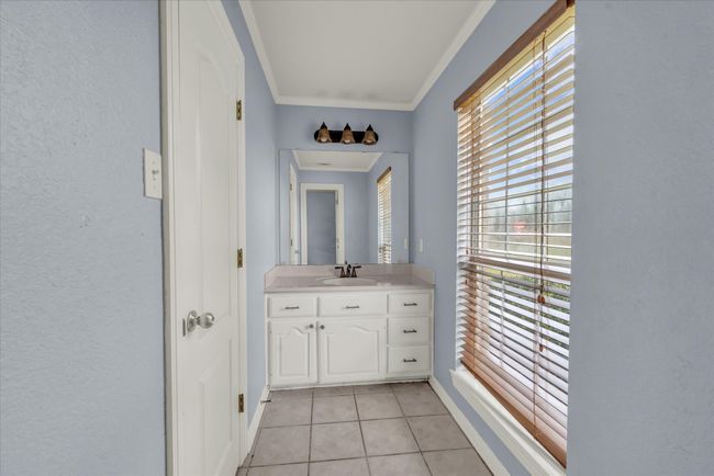 Bathroom with tile patterned floors, vanity, and ornamental molding | Image 21