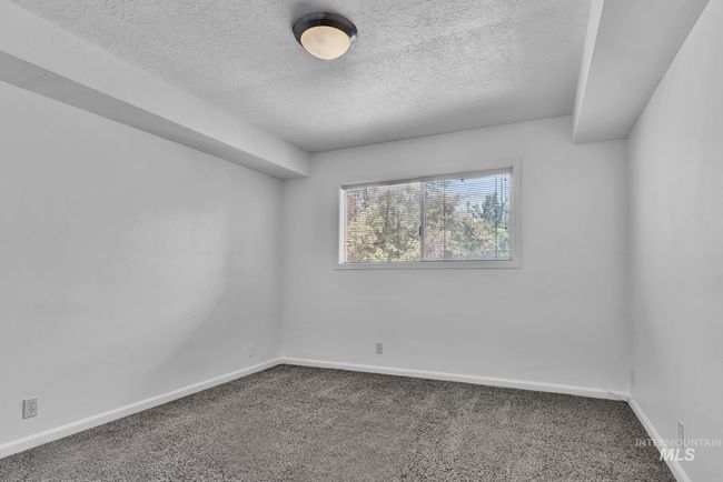 Unfurnished room with carpet and a textured ceiling | Image 18