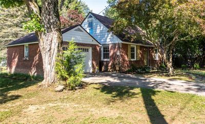 View of front of house with a garage and a front yard | Image 2