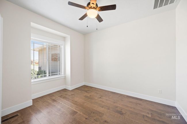Empty room with wood finished floors and ceiling fan | Image 22