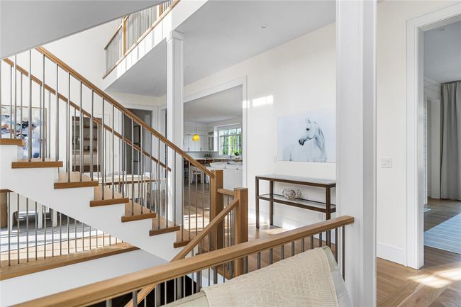Staircase with wood finished floors and baseboards | Image 8