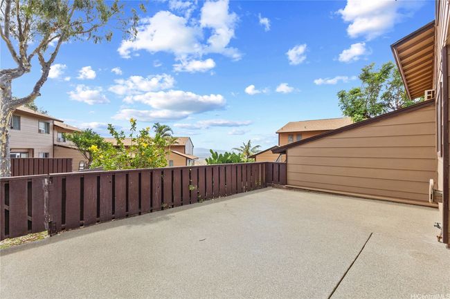 large gated lanai that leads out to green space | Image 19