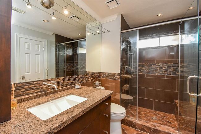The private ensuite bathroom is spacious and stylesh. Notcie the large walk in shower! | Image 37