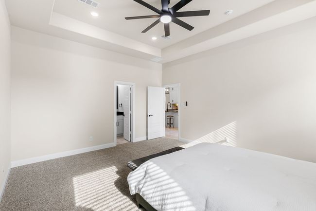 Primary Bedroom featuring recessed lighting, light carpet, and a raised ceiling | Image 17