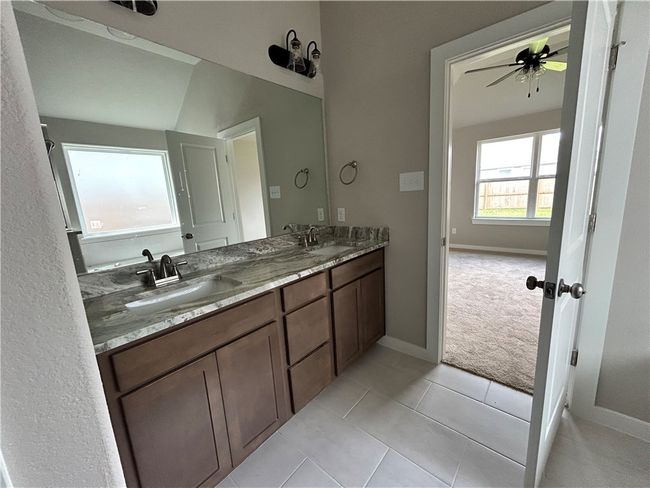 Bathroom featuring double vanity, a ceiling fan, and tile patterned flooring | Image 10