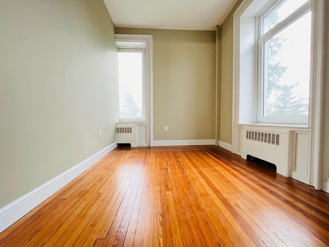 Second bedroom with large windows. | Image 9