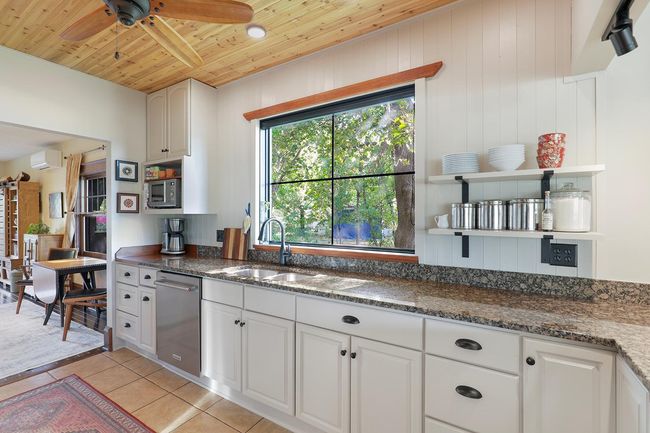 Sprawling counters and storage in a cook-centered kitchen. | Image 11